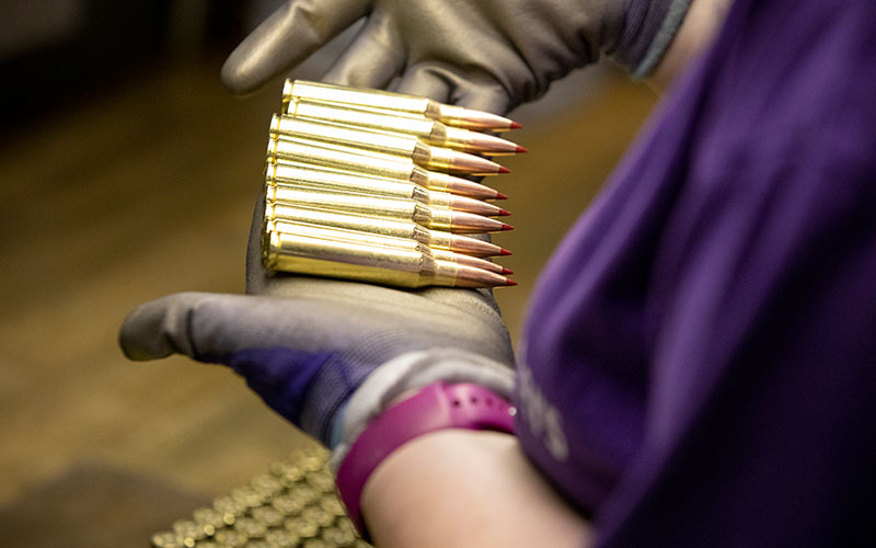 Hornady worker inspects rifle ammunition for quality control